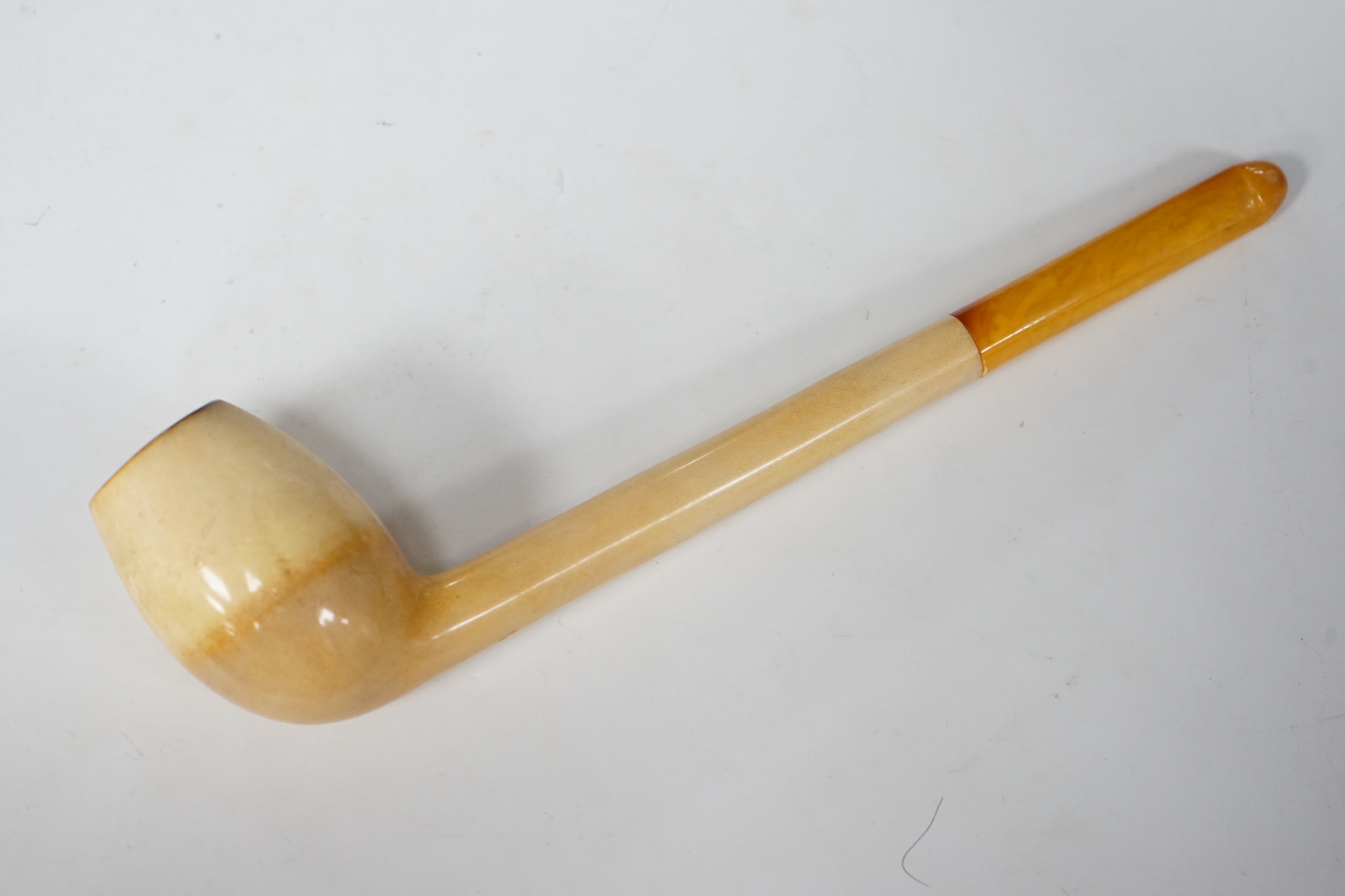 A cased and stamped Vienna Exhibition 1873 composite bowled pipe and amber mouthpiece, 26cm long